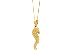 Close-up view of a stunning 10K gold seahorse necklace hanging from a delicate chain, showcasing its elegant design and intricate details.