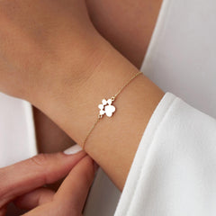 Luxurious 14K Gold Paw Bracelet worn on a wrist, showcasing its elegant and eye-catching paw motif.